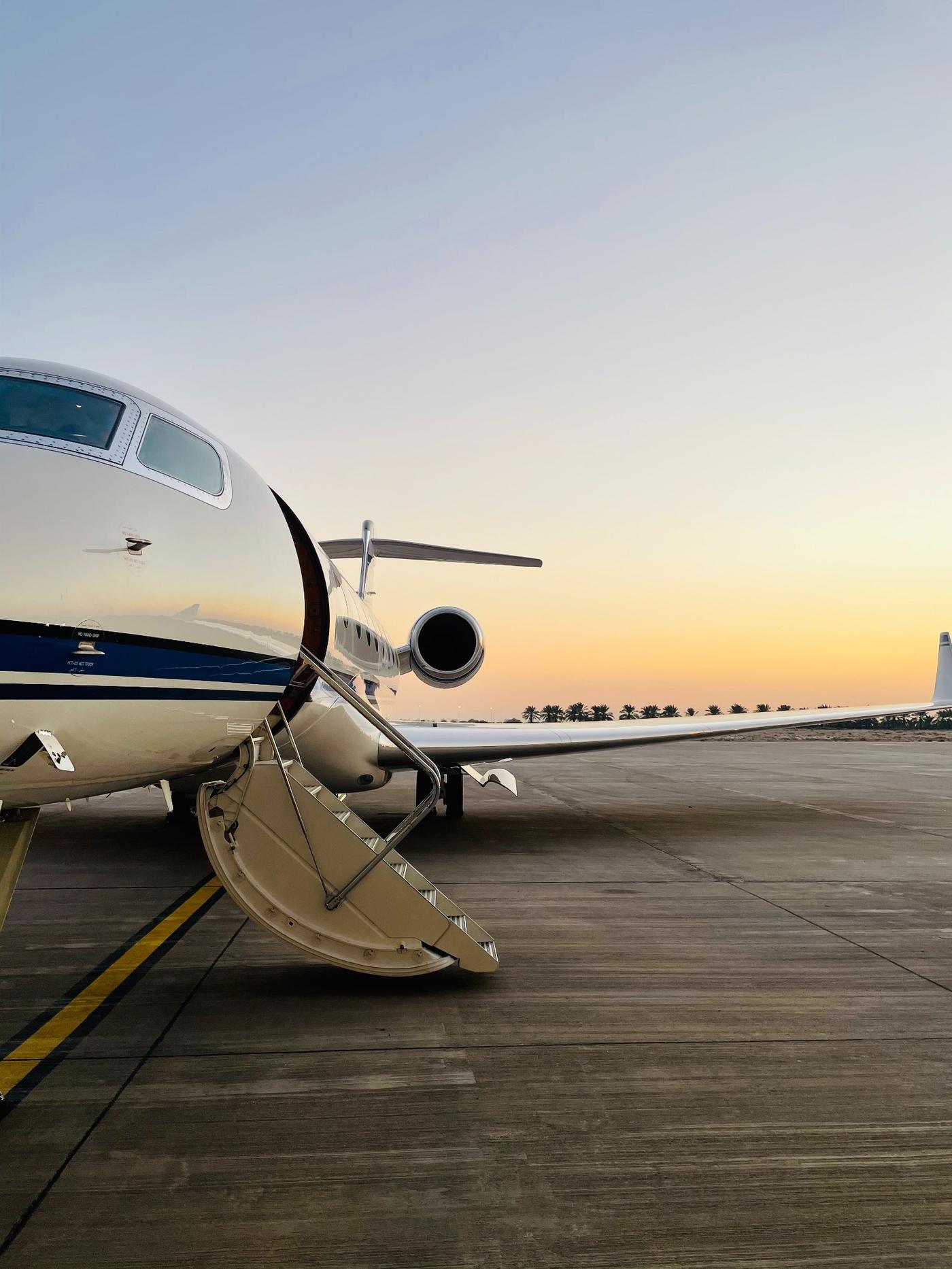 Private jet on the ramp at sunset